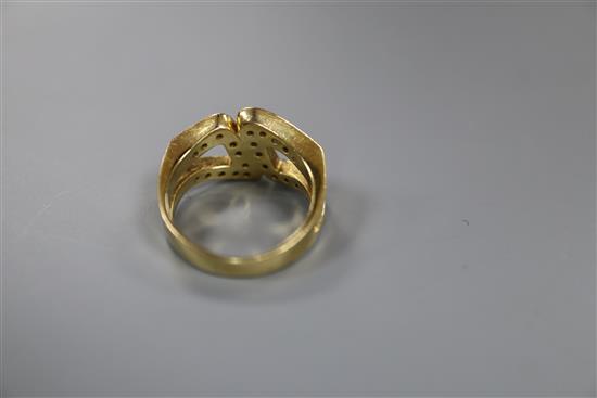 A modern 18ct gold and diamond set stylised buckle ring, size M, gross 7.8 grams.